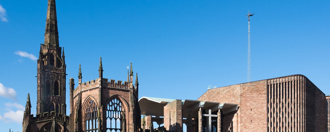 The ruined spire of the old St Michael's Cathedral in Coventry beside the 1960s cathedral built next to it