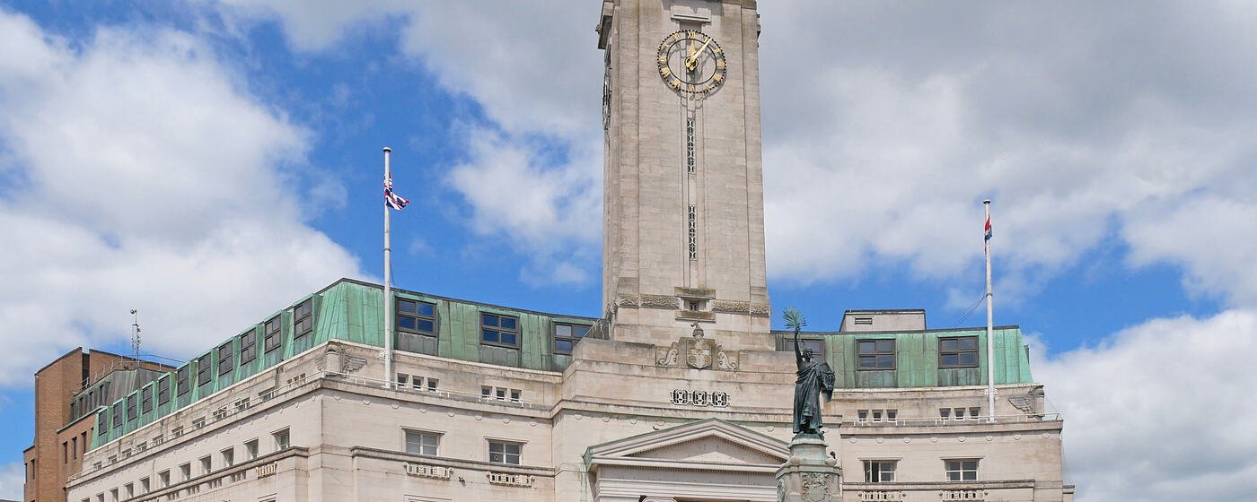 Luton Town Hall and its clock tower, with the town war memorial standing in front of it